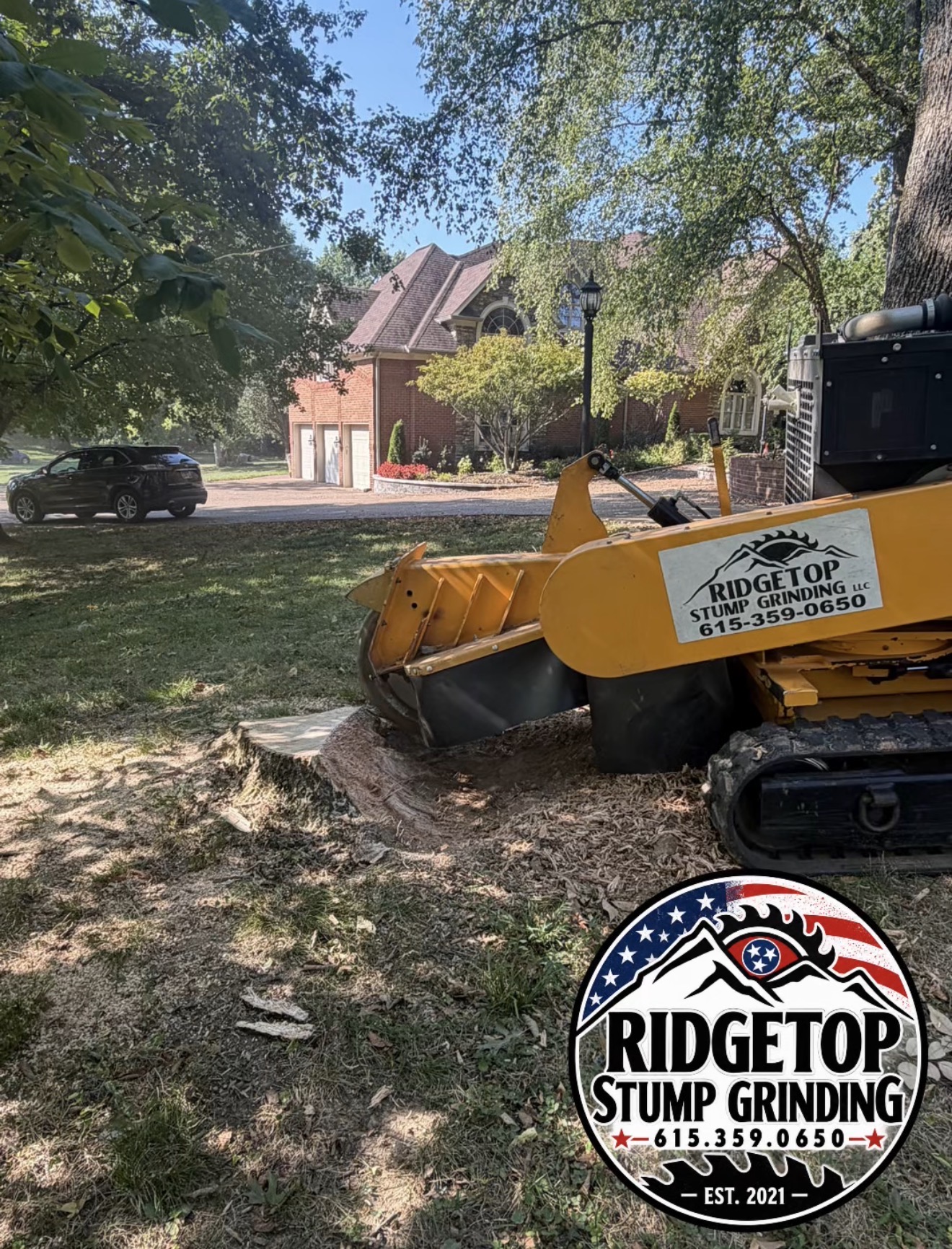 RidgeTop stump grinder working beside a large tree stump