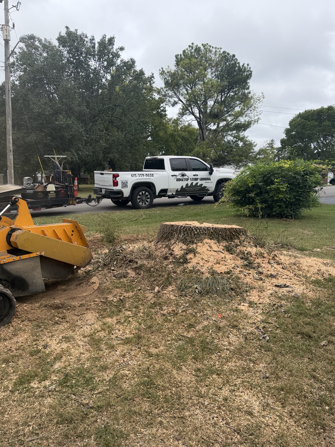 RidgeTop grinder and truck at a stump-grinding job